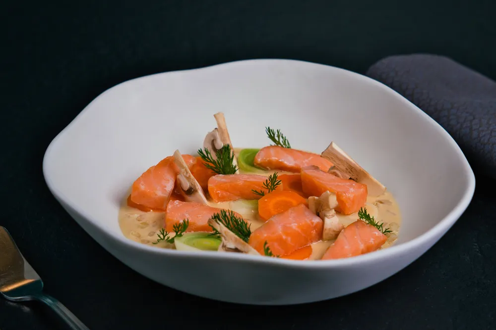 Salmon belly fish soup poached blanquette-style, pearl barley with skyr