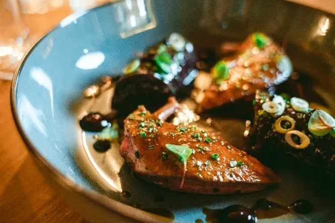Juniper-roasted pigeons, cromesquis legs, red cabbage and blueberry embeurrée